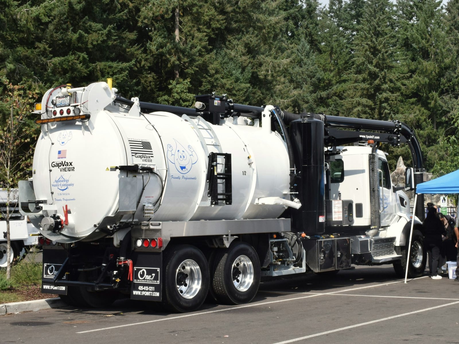 Professional septic tank pumping truck servicing a residential property